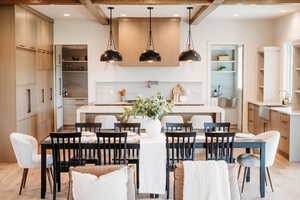 Dining space featuring light wood-type flooring, built in features, recessed lighting, and coffered ceiling