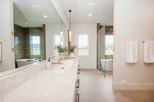 Welcome to your own spa-like primary ensuite featuring walk-in shower with a soaking tub, euro-glass, enlarged vanity, and light tile patterned floors