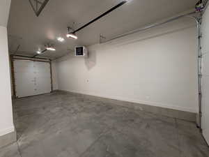 Garage with a heating unit and a garage door opener