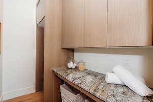 Main level laundry with folder countertop & modern cabinets