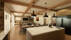 Kitchen with modern cabinets, built in fridge, decorative light fixtures, an island with sink, and beamed ceiling