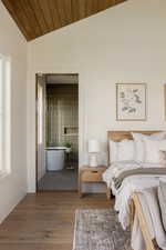 Vaulted wood-paneled ceiling with natural wood-finish flooring