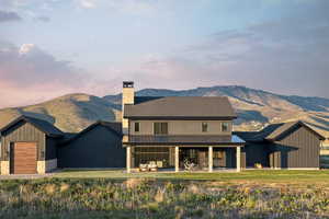 Contemporary two-story residence with dark siding and stone accents