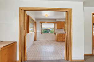 Hallway featuring light floors