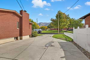 View of concrete driveway featuring a mountain view