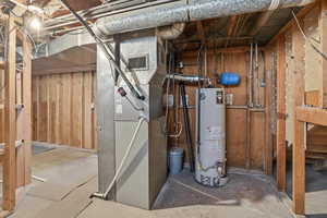 Utility room with water heater and heating unit