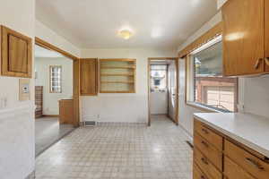 Kitchen featuring brown cabinets, light floors, and light countertops