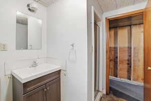Bathroom with vanity and a shower stall