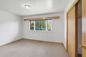 Unfurnished bedroom with a closet and carpet