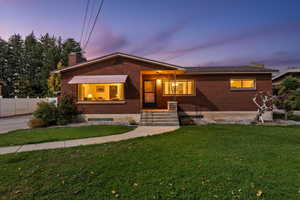 View of front of house with brick siding and a chimney