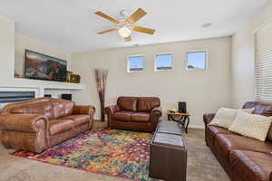 Living room with carpet and ceiling fan