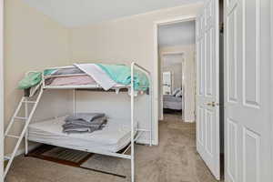 Bedroom with light carpet and a textured ceiling