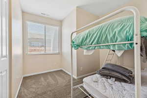 Carpeted bedroom with baseboards