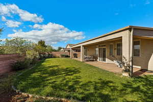 Fenced backyard with a patio