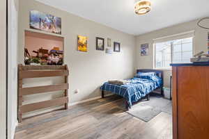 Bedroom with light wood-type flooring and baseboards