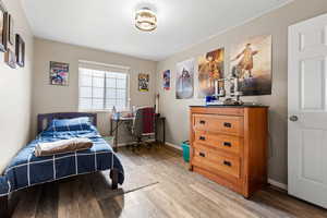 Bedroom featuring light wood finished floors and an office area