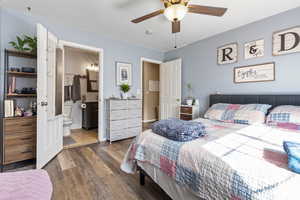 Bedroom with wood finished floors, ceiling fan, and ensuite bath
