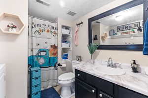 Full bath featuring a textured ceiling, vanity, light tile patterned flooring, and a shower with shower curtain
