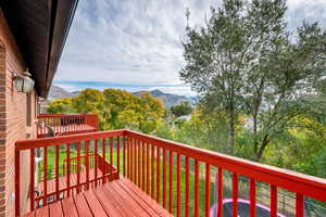 Wooden terrace featuring a mountain view