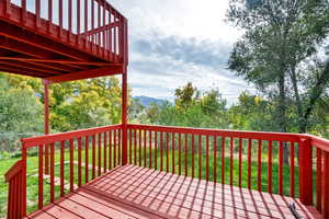 Wooden deck with view of wooded area