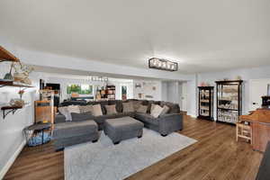 Living area with dark wood-style floors and a textured ceiling
