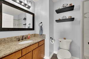 Full bathroom with vanity, light tile patterned floors, and a shower