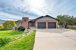 Ranch-style house with concrete driveway, brick siding, a garage, and a storage shed