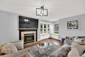 Living area featuring wood finished floors and a fireplace