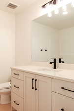 Bathroom featuring vanity and toilet