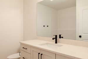 Bathroom featuring vanity and toilet