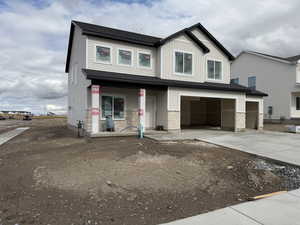View of front of house featuring driveway, an attached garage, stone siding, board and batten siding, and a shingled roof
