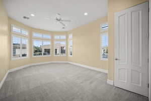 Spare room with light colored carpet, ceiling fan, and recessed lighting