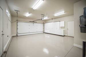 Garage featuring a central vacuum unit and baseboards