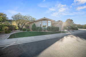 View of front of house featuring stucco siding, an attached garage, and concrete driveway