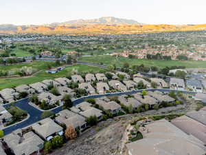 Aerial perspective of suburban area featuring a local golf course and a mountainous background