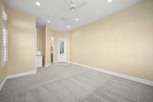 Empty room featuring recessed lighting, light carpet, and a ceiling fan