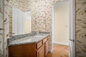 Bathroom featuring vanity and wallpapered walls