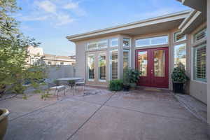 Property entrance with stucco siding, french doors, and a patio