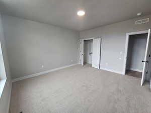 Unfurnished bedroom with carpet floors and a closet