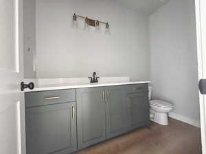 Half bathroom featuring vanity and toilet