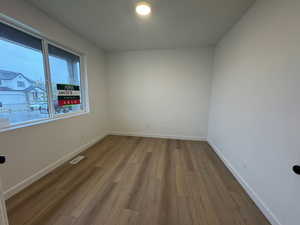 Unfurnished room featuring baseboards and light wood-style flooring
