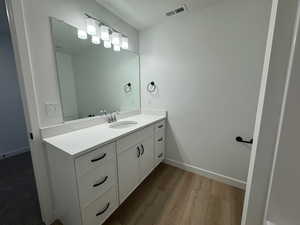 Bathroom featuring vanity, light wood-type flooring, and a textured ceiling