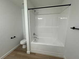 Full bathroom with bathtub / shower combination and wood finished floors