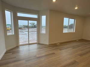 Unfurnished living room with light wood-style floors and recessed lighting