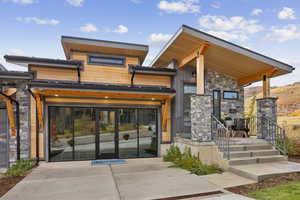 Entrance to property with stone siding