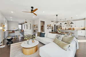 Living area with wood finished floors, ceiling fan, and recessed lighting