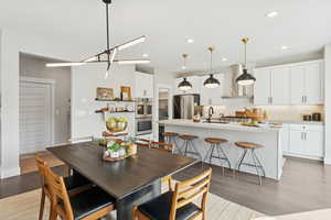 Dining room featuring light wood finished floors and recessed lighting