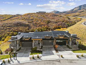Aerial view of property and surrounding area featuring a mountain backdrop