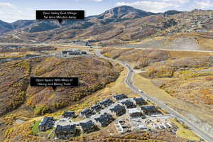 Aerial view of property and surrounding area with a mountainous background
