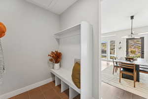 Mudroom with baseboards and light tile patterned floors